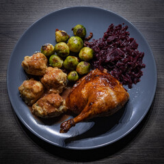 Fresh roasted goose with potato dumplings, brussels sprouts and red cabbage