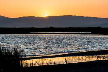 USA, California, San Joaquin River Valley. San Luis National Wildlife Refuge, sunset behind wetlands and coastal mountains.