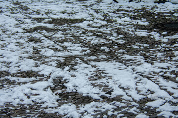 Non maintained snowy stone sidewalk during 2021 snow storm in Berlin Germany