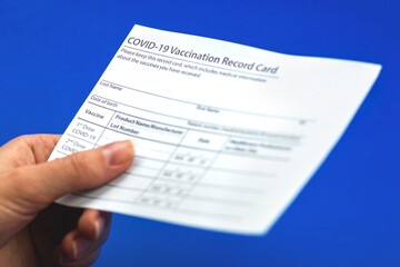 The person gives the COVID-19 vaccination record card, concept of healthcare in hospital during pandemic