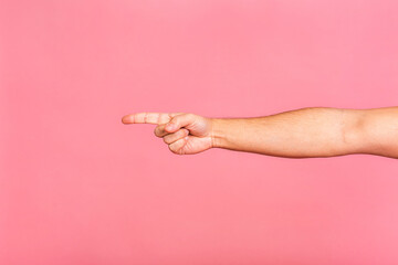 Fototapeta na wymiar Caucasian male hand point finger. Hand gestures - man pointing at virtual object with index finger isolated on pink background.