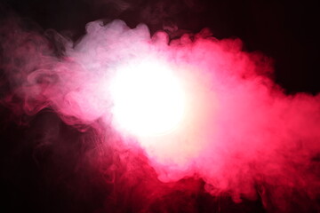 Smoke in red light on black background