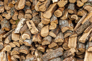 Firewood is lying in a woodpile close-up. Wood texture.