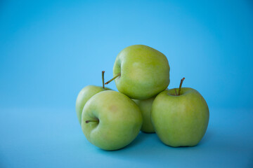 green apples on blue background