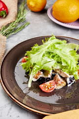 caesar salad on brown plate on gray concrete background