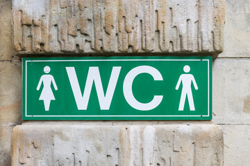 A green WC water closet sign.