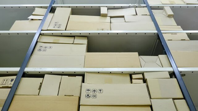 Unloading of the warehouse with boxes, time lapse. Gradual disappearance of the goods and emptying of the warehouse