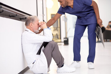 depressed doctor man after unsuccessful surgery, african colleague calm down. Health workers during the Covid19 coronavirus pandemic