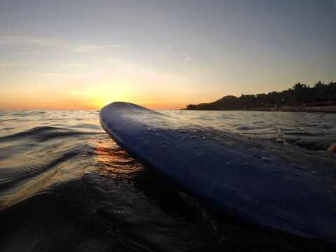 sunset on the beach while surfing