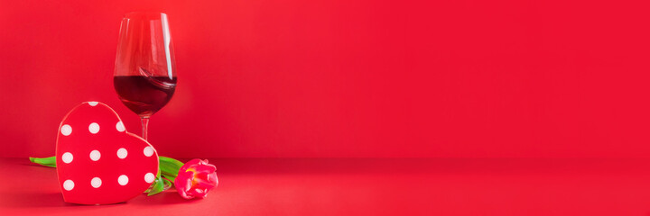 Banner with glass of wine, heart shaped gift box and flower on red background. Love romantic celebration of Valentine's Day, womens day, mothers day