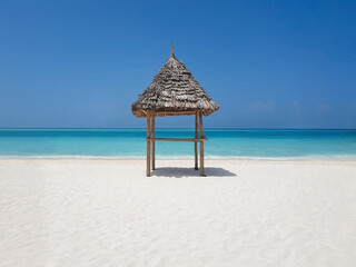thatched beach canopy or parasol on the beach, ocean, empty beach