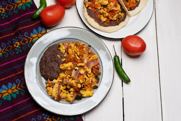 Scrambled eggs and refried beans tacos on white background. Mexican food