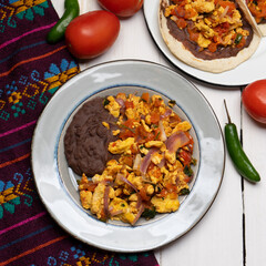 Scrambled eggs and refried beans tacos on white background. Mexican food