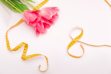 Bouquet of pink tulips on white background with numeral eight and copy space, empty text place. Sale and delivery of flowers online service. International woman day. Happy mother day. Holiday card