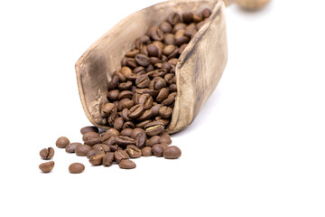 Coffee beans in a wooden scoop isolated on a white background. Roasted coffee beans isolated. A wooden scoop with coffee
