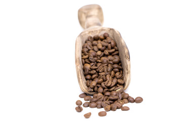 Coffee beans in a wooden scoop isolated on a white background. Roasted coffee beans isolated. A wooden scoop with coffee