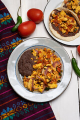 Scrambled eggs and refried beans tacos on white background. Mexican food