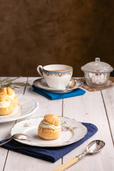 Vanilla cream puffs on a wooden table