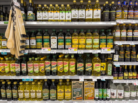 PORT CHARLOTTE, FLORIDA - MARCH 2, 2021 : Bottles of various brands of olive oil on grocery store shelves at a local supermarket.