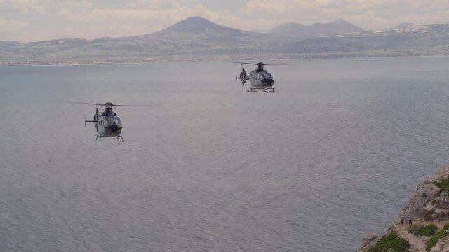 Aerial of Private Helicopters Flying Over the Ionian Sea and Towards Cliffs