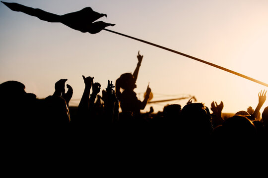 Silhouette of people on a big festival event.