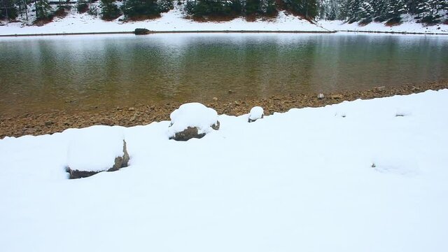 Amazing winter landscape with snowy mountains and clear waters of Green lake (Gruner see), famous tourist destination in Styria region, Austria