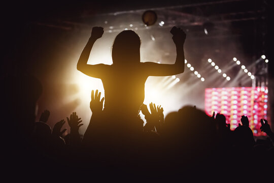 Girl silhouette on a big concert show.