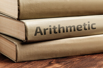 Educational books on arithmetic lie on a wooden table