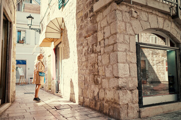 Fototapeta na wymiar Traveling by croatia. happy young woman in coat walking by Split Old Town.