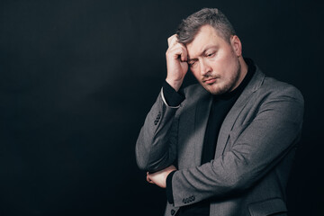 Man standing with hand on chin thinking about question, pensive expression. Thoughtful face. Doubt,...