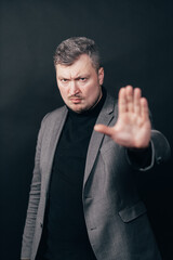 Business man making stop sign, open hand, making five hand gesture. Warning expression with negative and serious gesture on the face