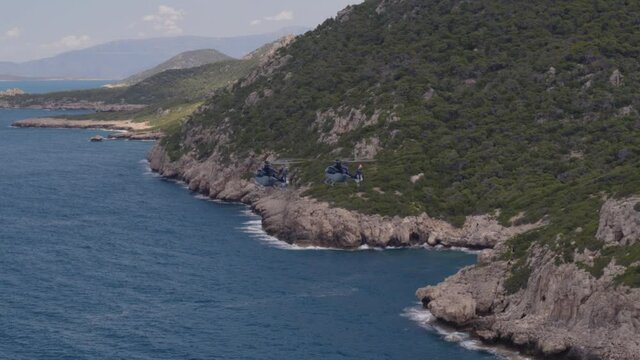Aerial of Private Helicopters Flying by Mountains and Over Ionian Sea in Greece