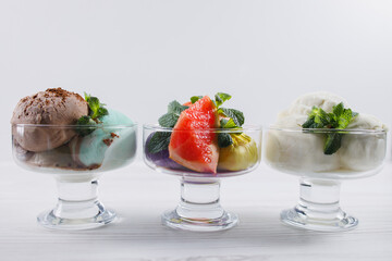 Summertime. Ice-cream scoops in glass sundae bowls. Holiday, vacation, summer delicious refreshing treats