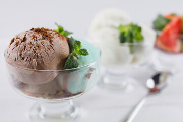 Ice-cream. Flavored sundae and fruit sorbet variety in glass bowls, refreshing dessert for summertime. Tasty homemade food, natural sweets