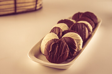 alfajores de chocolate: a traditional dessert from Latin America, Argentina and Uruguay. Vanilla cookies with dulce de leche, chocolat and coconut