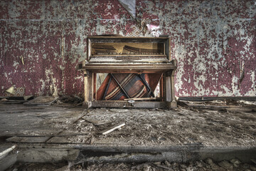 Old broken piano in an abandoned ruined building