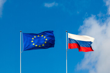 EU flag and Russia flag are on blue sky. Concept relations between Europe and Russia - 417732121