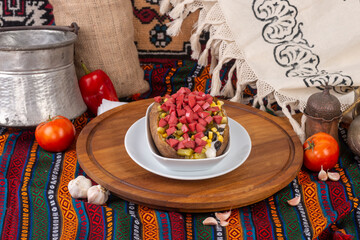 Baked potato varieties ready to be served on a white plate.