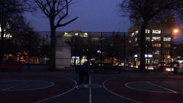Man Practicing Basketball, Putting in Work at Night in NYC Park