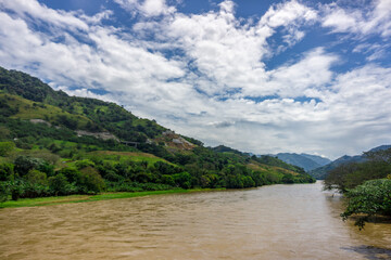 Fototapeta premium deep blue sky with abudant riven in the forest cauca rives