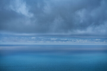 USA, California, Big Sur Coast. Storm clouds shade ocean.
