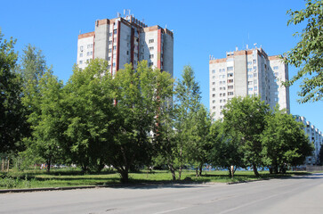 modern high multi storey residential buildings in the city buildings with a park and trees for walking and relaxing in the summer