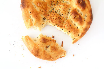 Slices of Ramadan Pita (Ramazan Pidesi) Traditional Turkish bread for holy month Ramadan on white background. Ramadan concept.