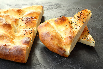 Slices of Ramadan Pita (Ramazan Pidesi) Traditional Turkish bread for holy month Ramadan on white background. Ramadan concept.