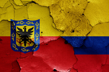 flags of Bogota and Colombia painted on cracked wall