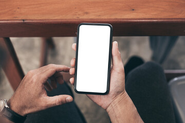 cell phone blank white screen mockup.man hand holding texting using mobile on desk at office.background empty space for advertise.work people contact marketing business,technology
