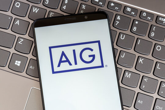 Toronto, On, Canada - February 27, 2021: AIG logo on smartphone screen on keyboard. AIG is an American multinational finance and insurance corporation. 