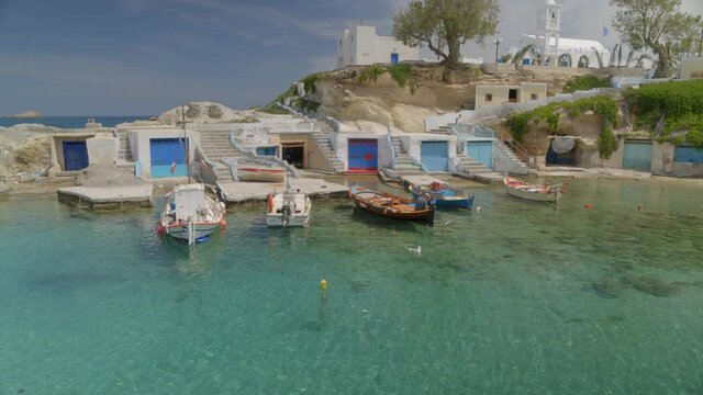 Lowering Aerial Pan Boats Docked on the Fishing Village of Mandrakia in Milos