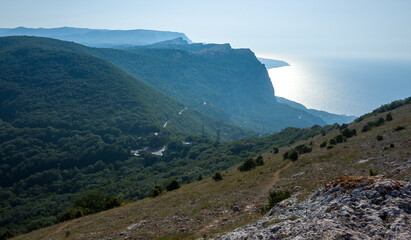 Mediterranean landscape. Forested rocks of the Black Sea coast of the southern coast of the Crimean Peninsula on a clear sunny day.