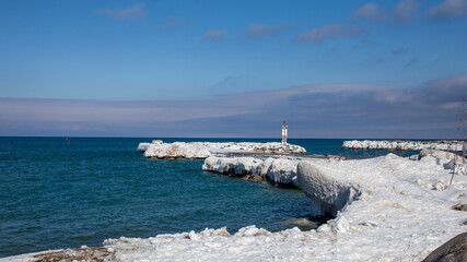 The frozen pier at the entrance of the Thornbury Yacht Club marina in the winter. Large ice sickles hang down from the shoreline after winter storms pack ice around the beach. © AshleyBelle